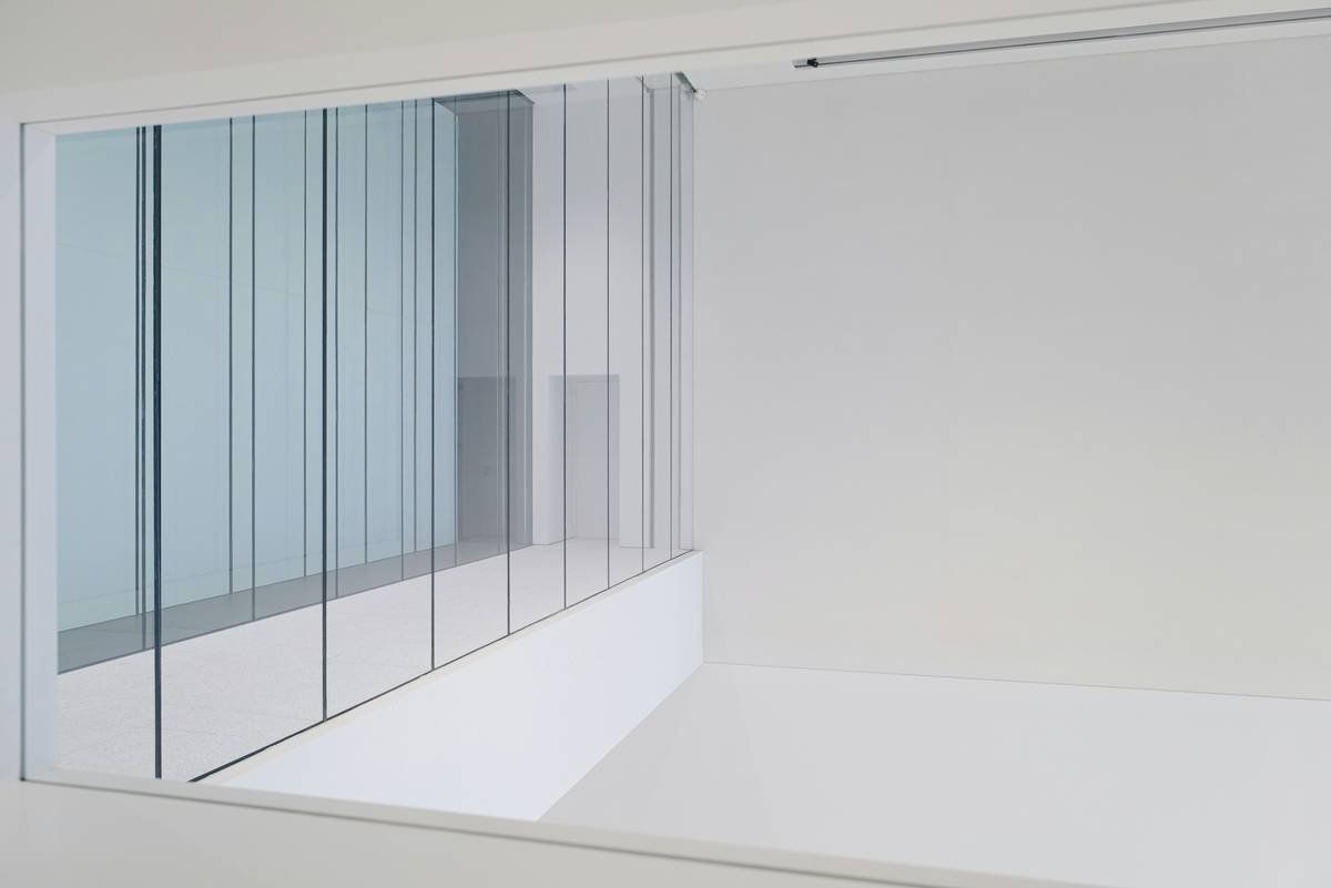 Close-up of bifold shower door hinges and seal system